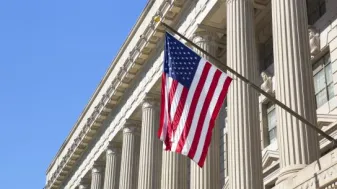 American flag hanging outside a federal building.